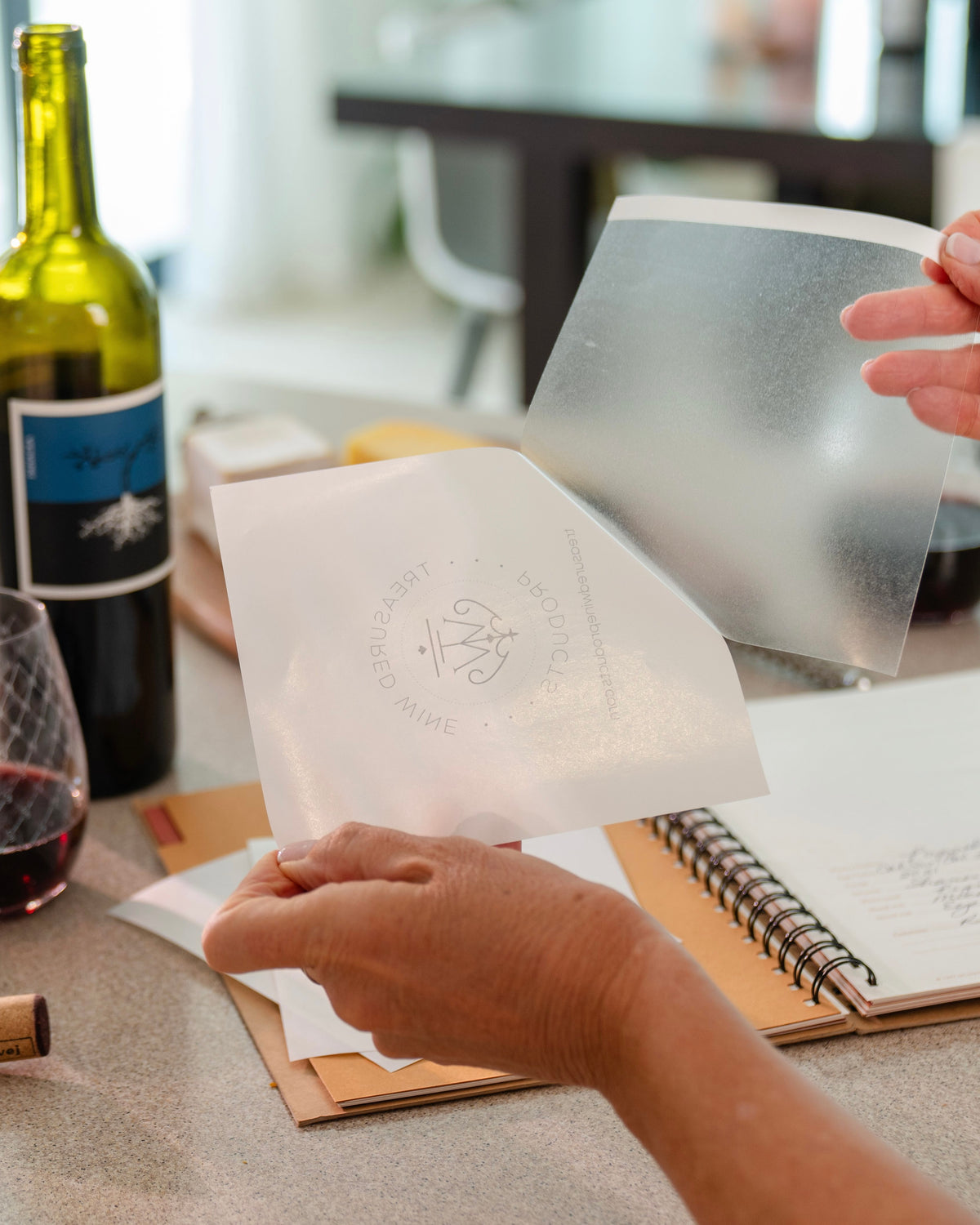 Peel the wine label removal sheet, while holding the handy starter strip, away from the backing paper featuring the Treasured Wine Products logo. Put backing paper aside for use after removal